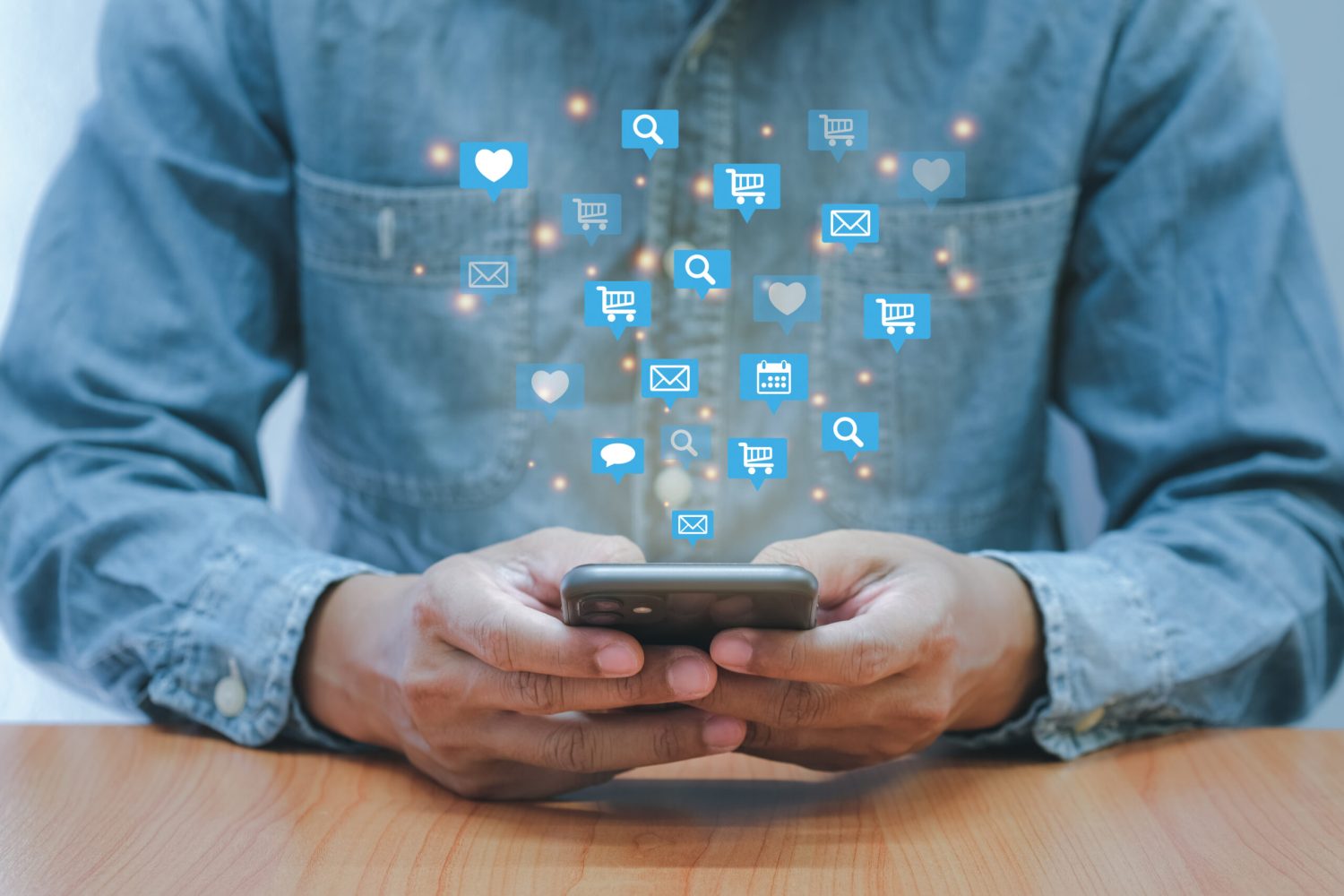 Social media interactions on smart mobile phone. Concept of noti Social media interactions on smart mobile phone. Concept of notification icons of like, message, email and comment. Hands holding the device.
